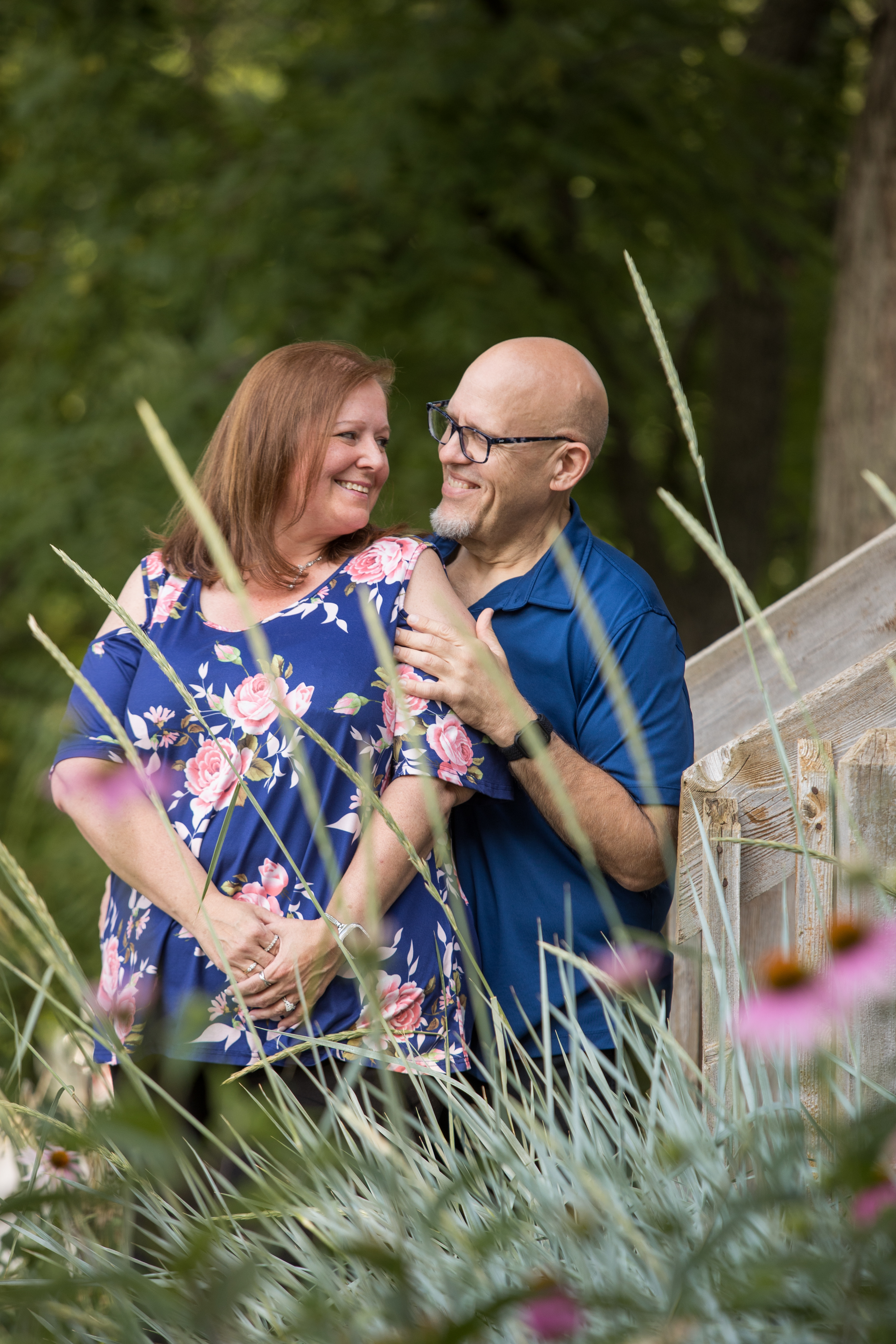 engagement photo with flowers in the foreground