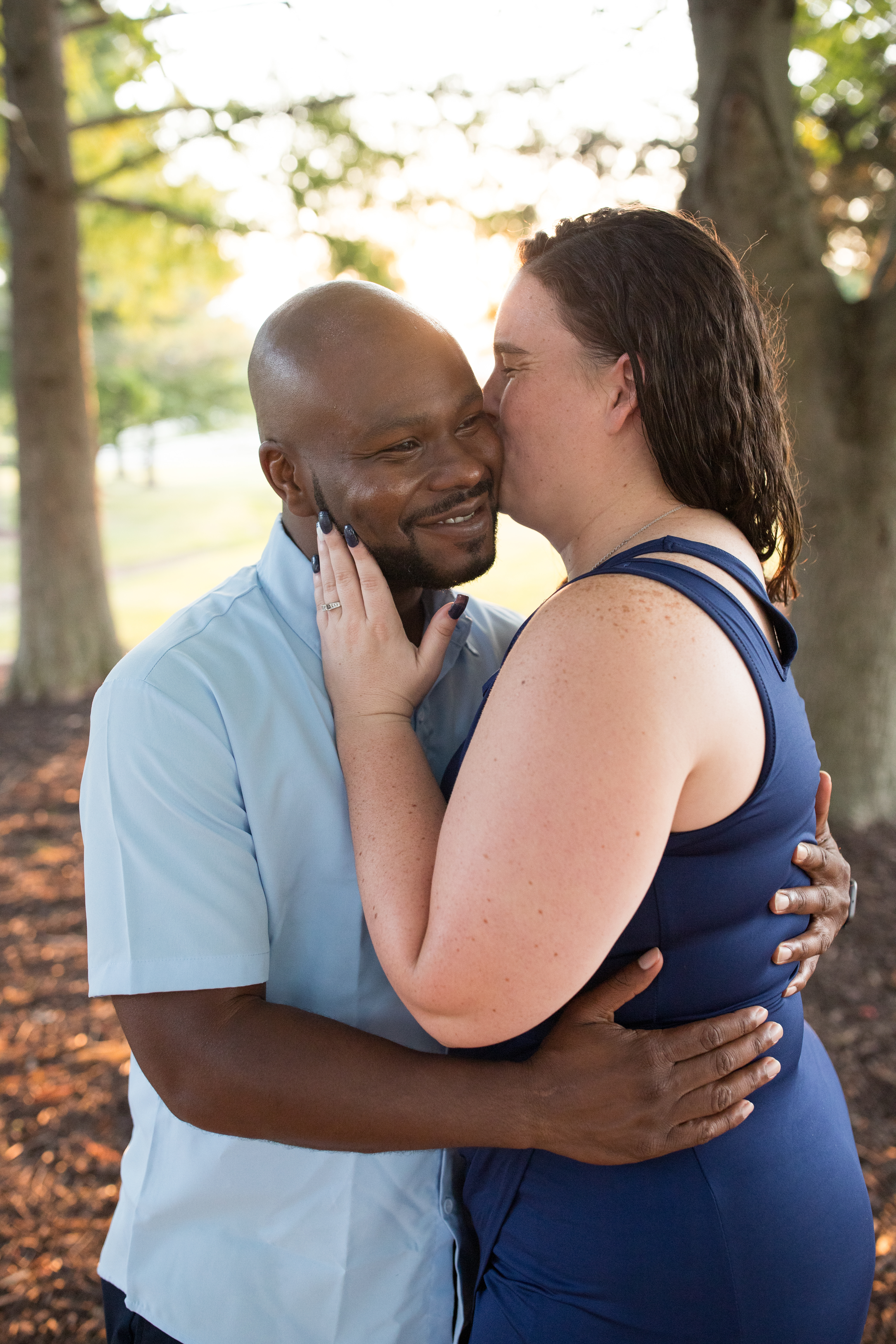 woman kissing her fiancé on cheek
