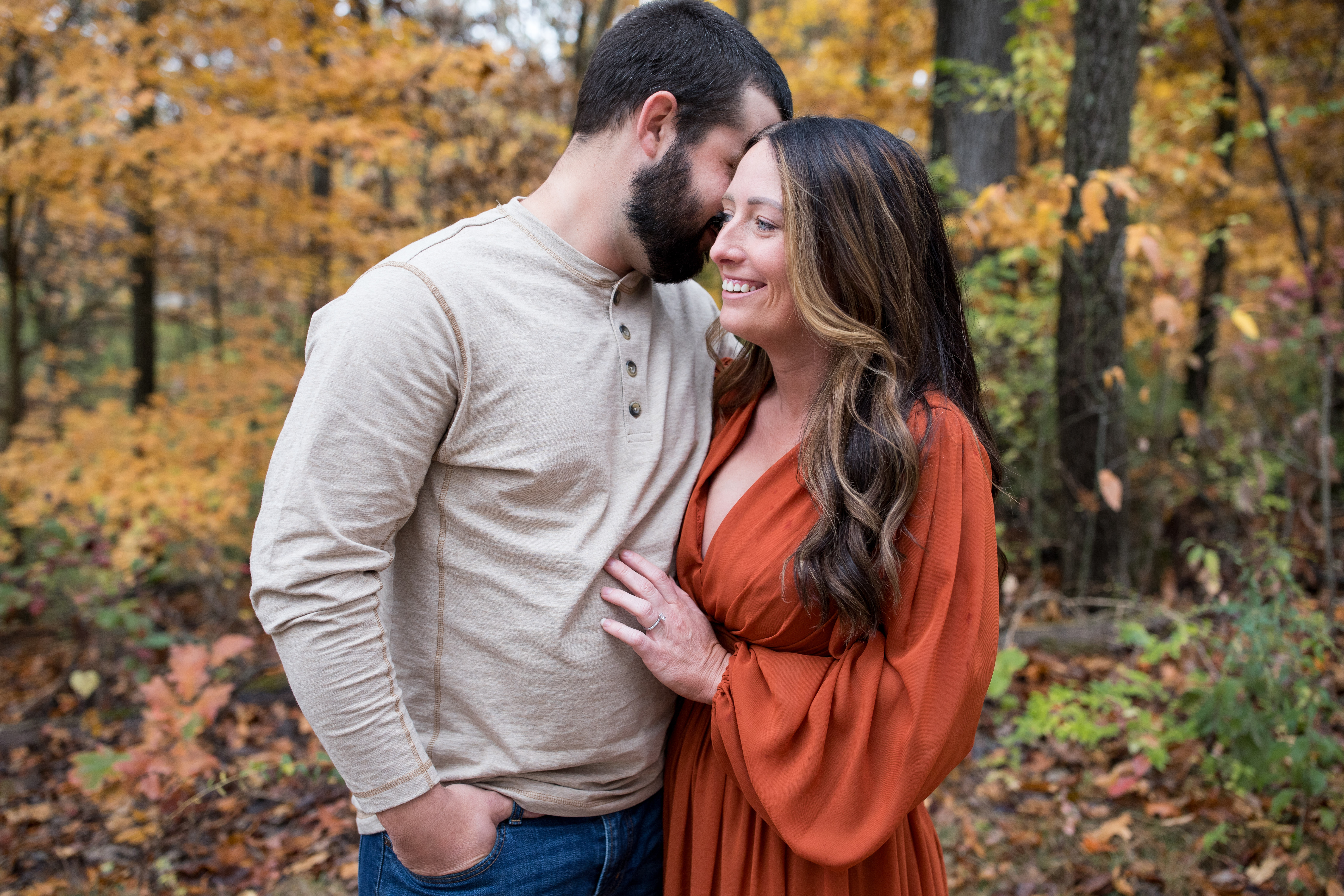 man kissing his fiancée on the cheek