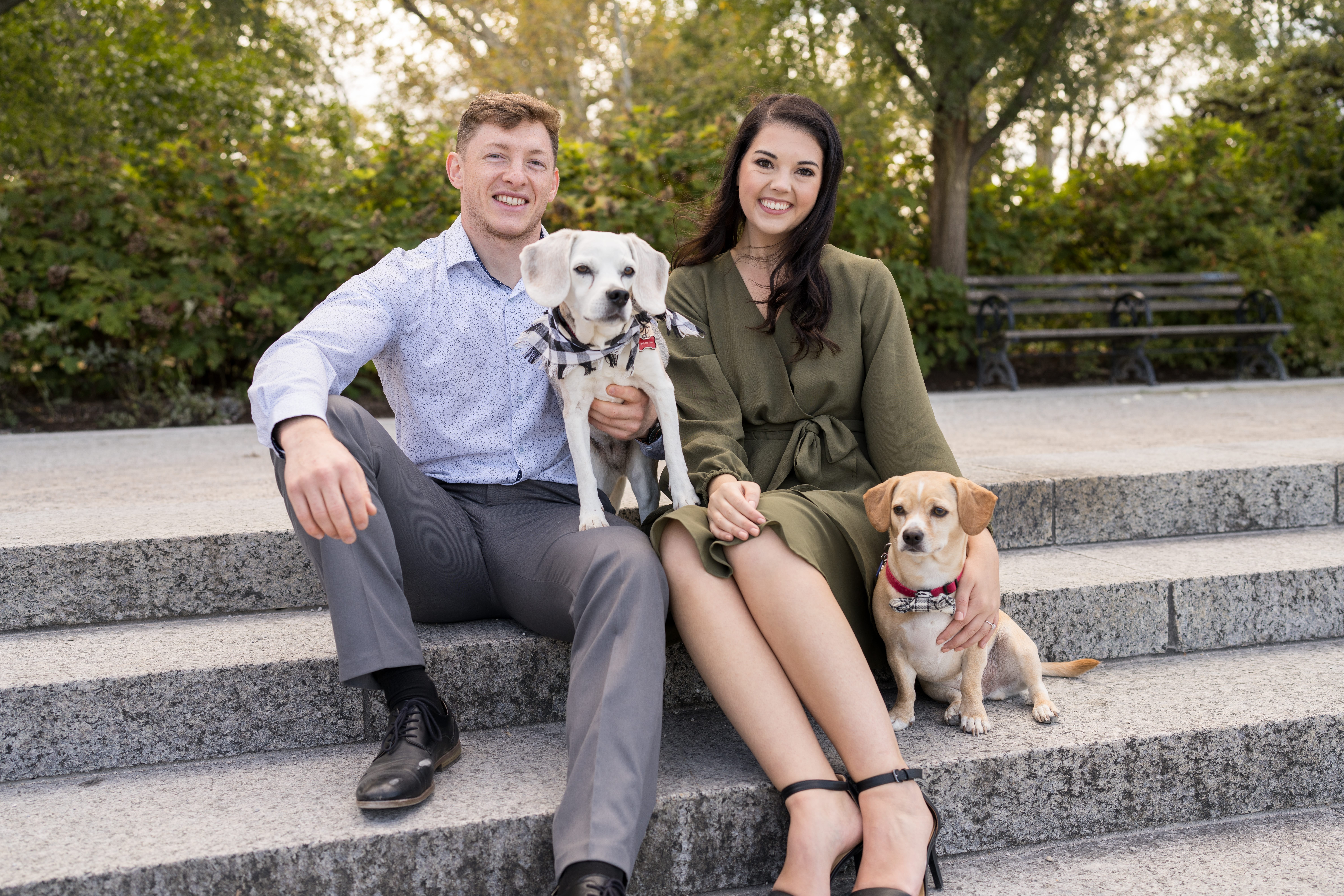 couple smiling with their dogs