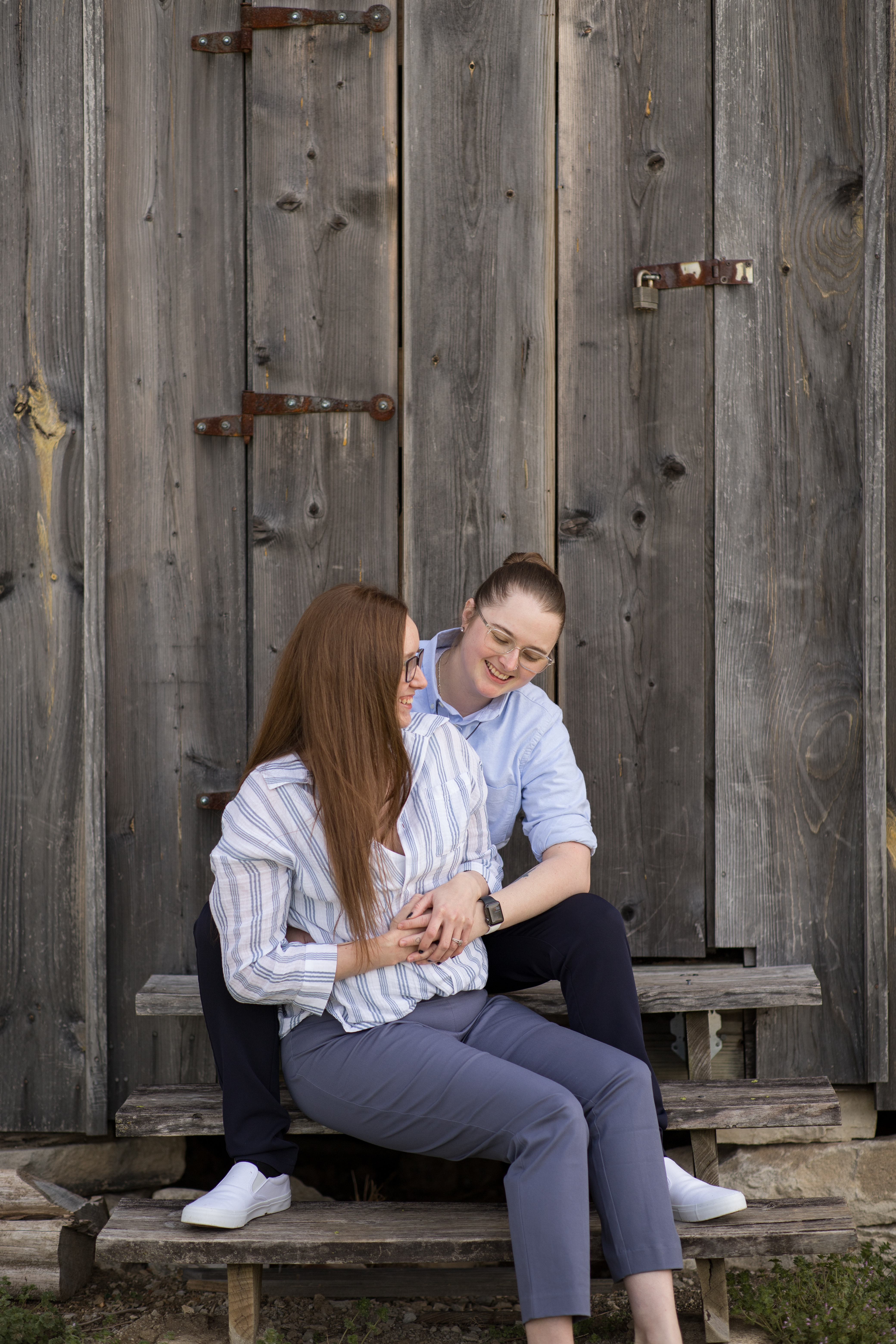 couple sitting on steps during engagement shoot
