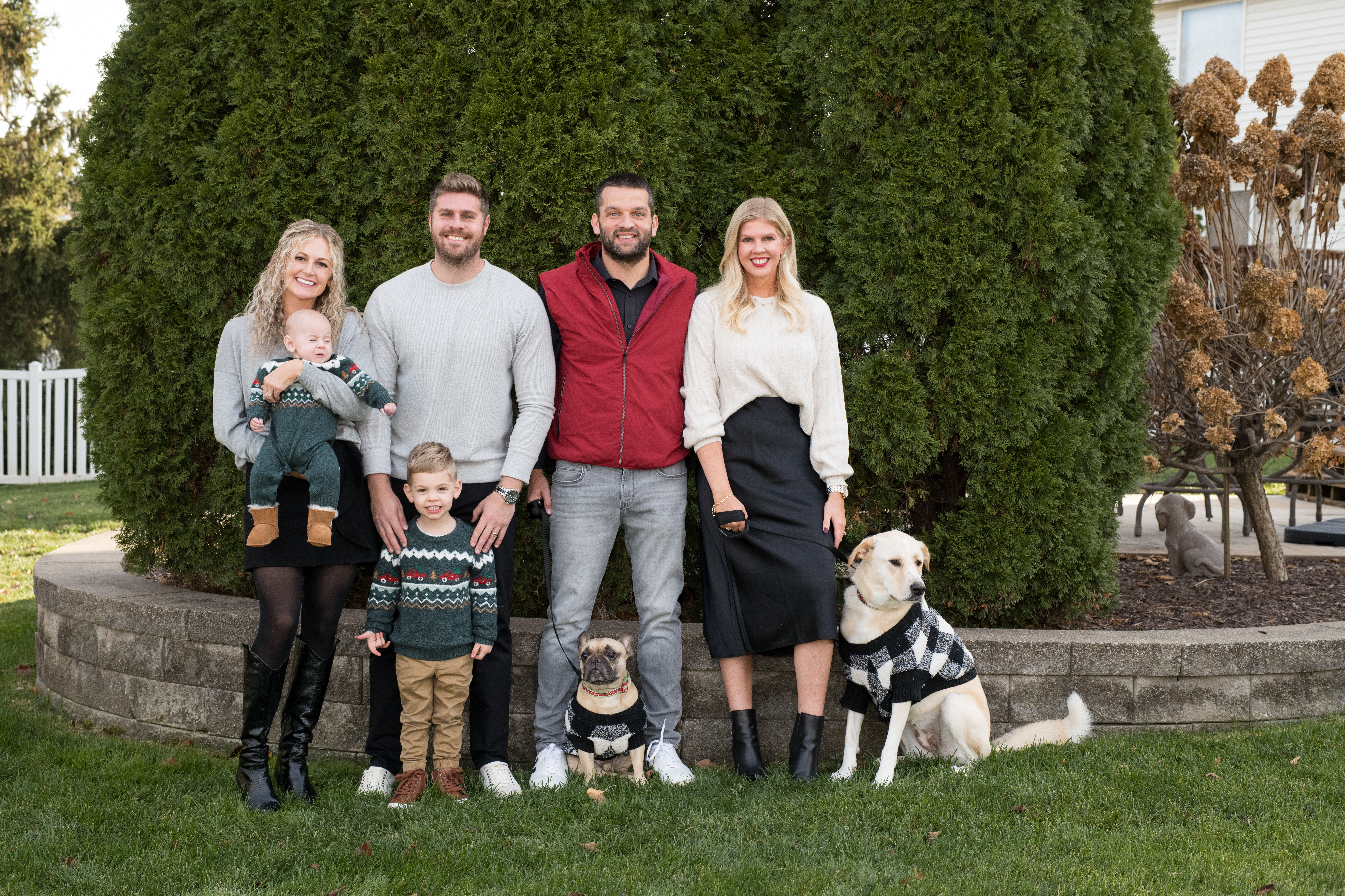 sibling family photo with their kids and pets
