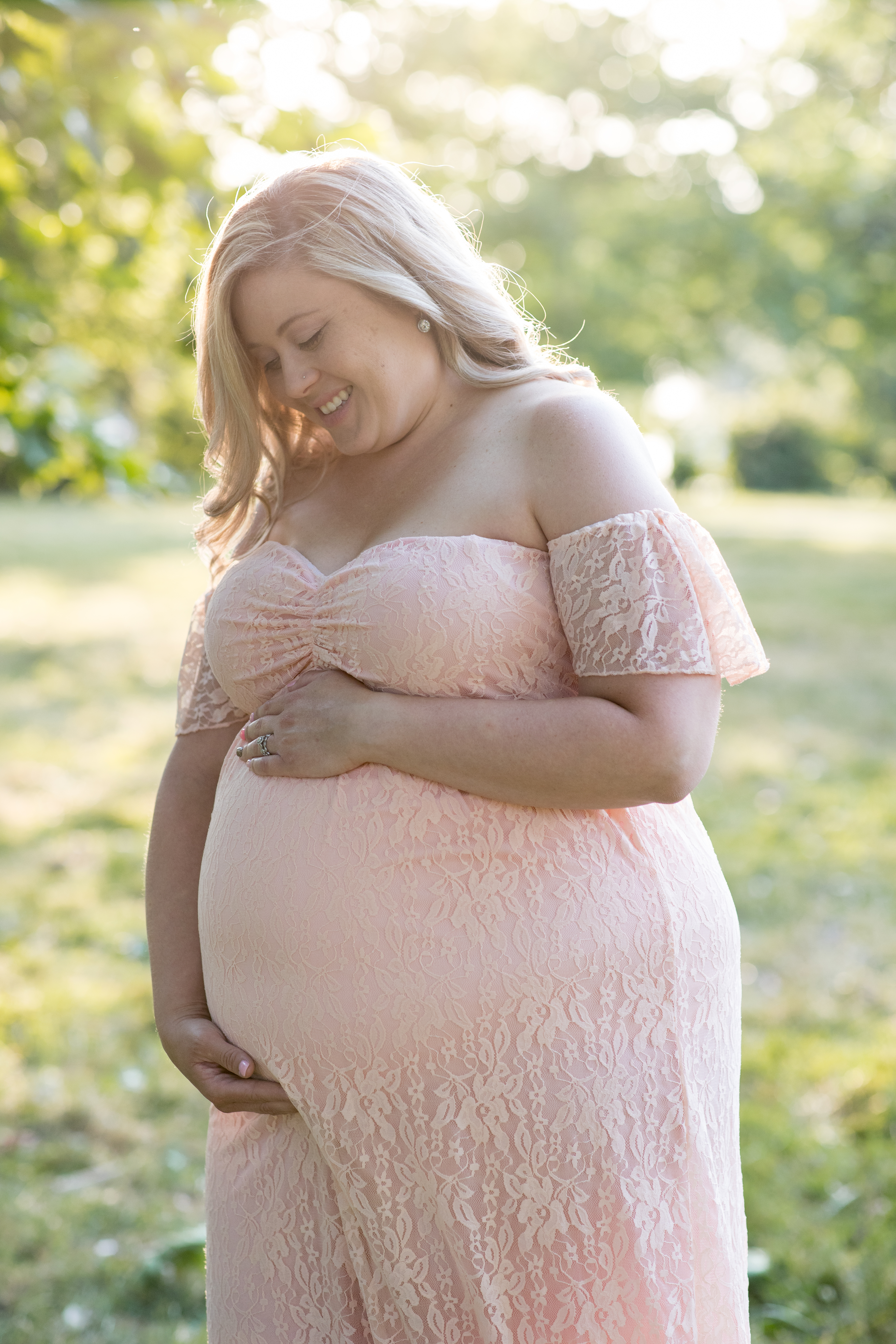 pregnant woman in peach lace dress maternity photo