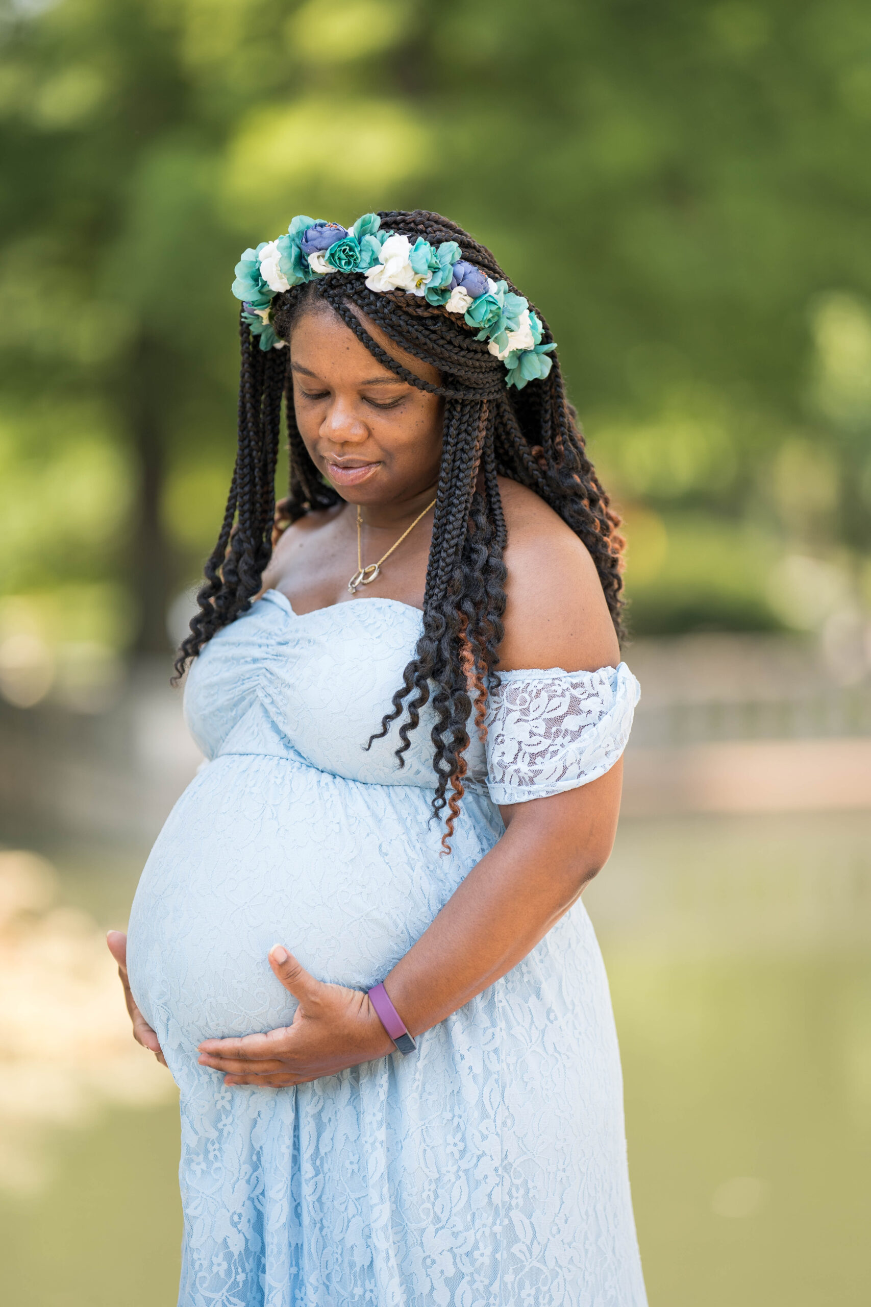 maternity photo shoot of an expecting mother in a baby blue dress 